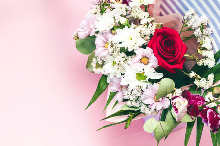 Box in the form of an envelope with a bouquet of flowers. Orchids, greenery, chrysanthemums and...