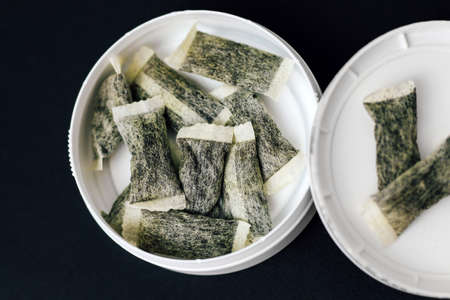 Round box with snus. Cigarette substitute, nicotine pouches.の写真素材