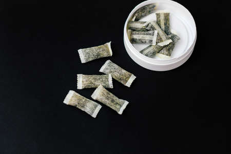 Round box with snus. Cigarette substitute, nicotine pouches.の写真素材