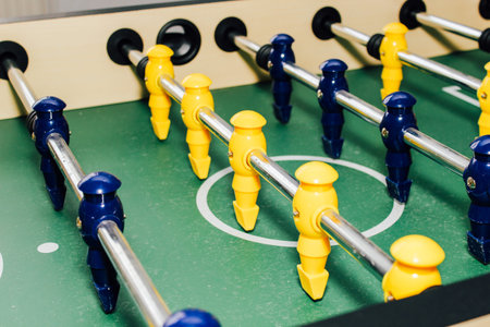 Table soccer. Game figures football players close up. An entertaining game for football fans.