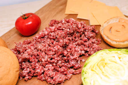 Fresh minced meat for making a burger at home. Ingredients for a homemade cheeseburger.の写真素材