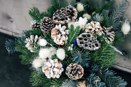 New Year's composition of dried lotus flowers, cones and spruce branches. DIY bouquet for Christmasの写真素材