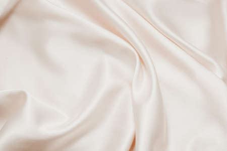 Nude silk texture. Satin delicate powdery glitter finish, beautiful backdrop for designersの写真素材