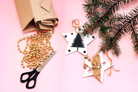 Preparing for packing Christmas gifts. Flatley made of scissors, toys, beads, craft paper and spruce branches.の写真素材