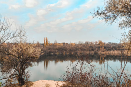 Landscape of a small lake with clear water. Autumn lake view.