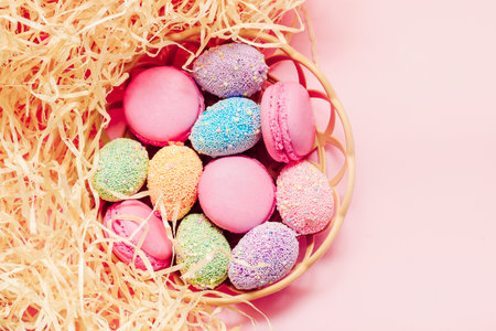 French pink macaroon cookies with Easter decorative eggs.の写真素材