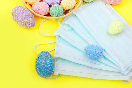 Multicolored easter eggs with medical protective mask, concept.の写真素材