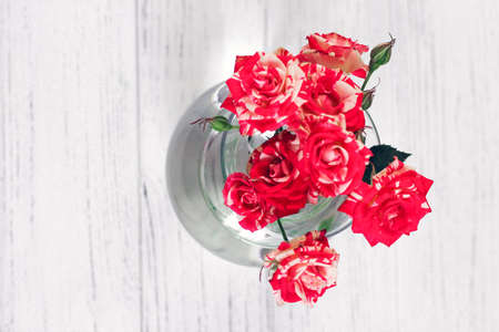 Bouquet of red roses in a vase on a white background from boards.の写真素材