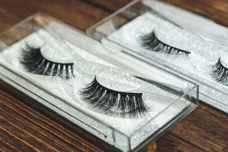 False eyelashes on a wooden background. Make-up for the eyelids.の写真素材