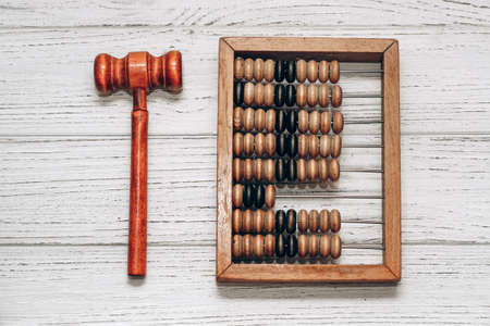 wooden abacus with judge gavel for sentencing on white backgroundの写真素材