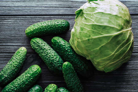 Cabbage with cucumbers top view on a background of wooden boards.の写真素材