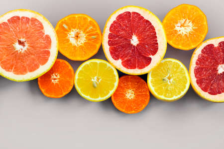 Sliced citrus on a white background. Grapefruit, lemon, tangerine.の写真素材