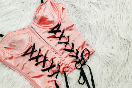 Sexy red corset with ties underwear on white fur.の写真素材