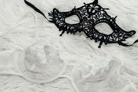 Snow-white underwear on white fur. Lace mask for sexy games.の写真素材