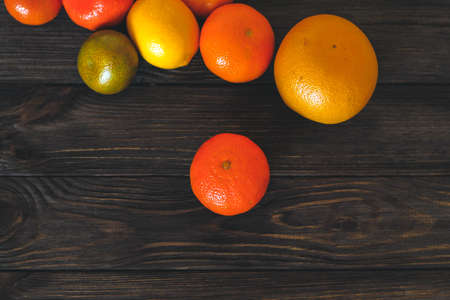 Citrus grapefruit, orange, tangerine on a background of wooden boardsの写真素材