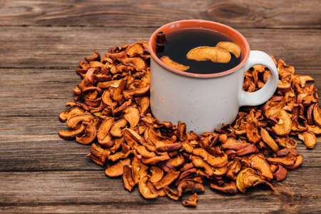 Dried apple slices close up, useful vitamins for drinks in a healthy diet. Cup with uzvar.の写真素材