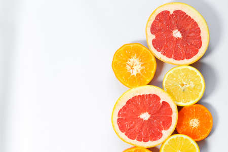 Sliced citrus on a white background. Grapefruit, lemon, tangerine.の写真素材