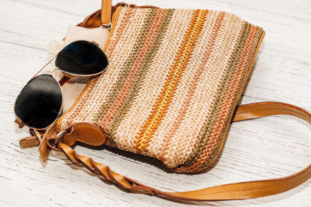 Tinted sunglasses with wicker beach straw bag. Summer flatley.の写真素材