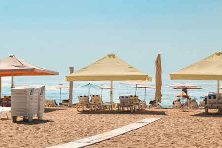sun umbrellas on the beach with sun loungers.