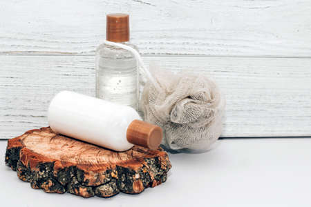 Cosmetic bottles for bathroom and washcloth on wooden background.の写真素材