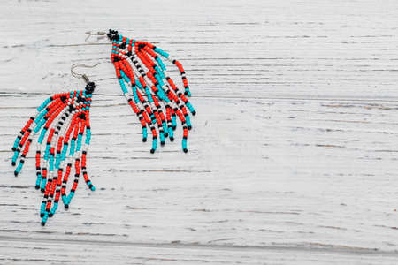 Ethnic decoration of an earring, visonane with a bead. Hand weaving beading, geometric pattern.の写真素材