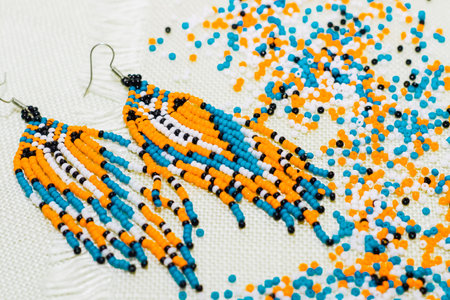 Ethnic decoration of an earring, visonane with a bead. Hand weaving beading, geometric pattern.の写真素材