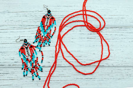 Ethnic decoration of an earring, visonane with a bead. Hand weaving beading, geometric pattern.の写真素材