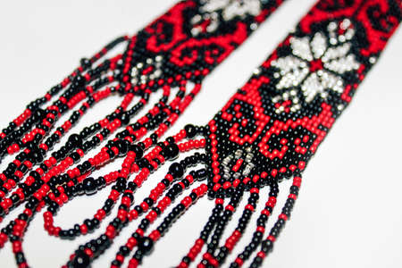 Black and red traditional handmade beaded gerdan on a white background.の写真素材