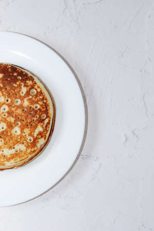 Pancakes in a snow-white plate. Rosy hot sweet breakfast.の写真素材