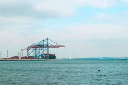 view from the shore to the port with cranes and containers.の写真素材