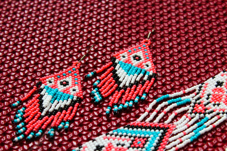 Pink blue traditional gerdan with handmade beaded earrings on white background.