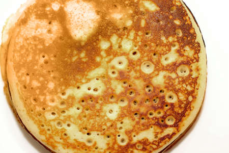 Pancakes in a snow-white plate. Rosy hot sweet breakfast.の写真素材
