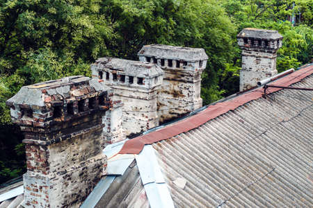 roofs of old houses with chimneys made of antique stone.の写真素材