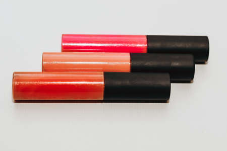 Three colorful bottles with trendy matte lipstick.の写真素材