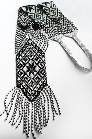 White with black traditional handmade beaded gerdan on a white background.の写真素材