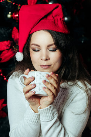 Girl with dark hair posing in a snowy forest.の写真素材