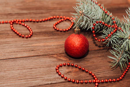 Christmas background with fir sprig and red toys on wooden boards.の写真素材