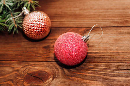 Christmas background with fir sprig and red toys on wooden boards.の写真素材