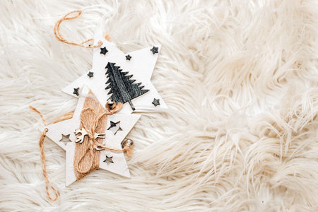 Wooden christmas toys on a fluffy white background.