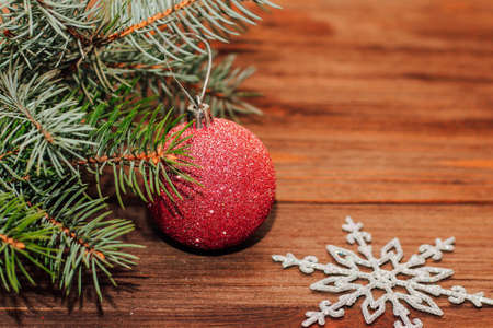 Christmas background with fir sprig and red toys on wooden boards.の写真素材