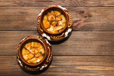Roast with mushrooms cooked in traditional pots in the oven.の写真素材