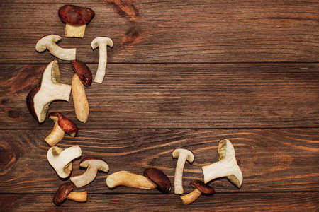 Forest mushrooms Boletus edulis on a wooden background with space for text.の写真素材