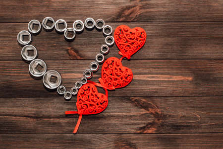 Nuts to a wrench, a set of tools in the shape of a heart. Valentine's Day gift for a man.の写真素材
