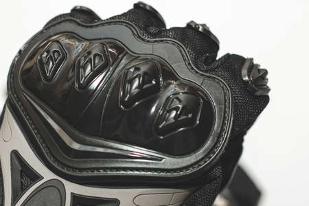 Black motorcycle gloves with protection pads for rider safety.の写真素材
