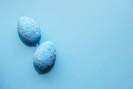 Blue Easter eggs on a pastel background.の写真素材