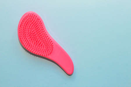 Comb plastic roses for delicate combing on a paper background.の写真素材
