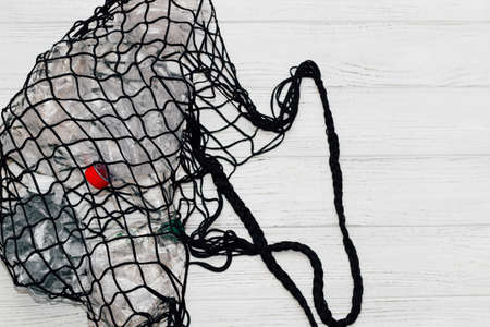 Black string bag with plastic bottles, ecology concept.の写真素材