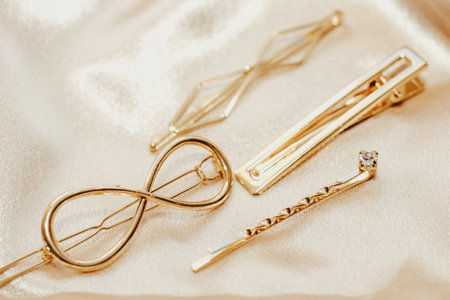 Golden hairpins on golden silk background, social media content.の写真素材