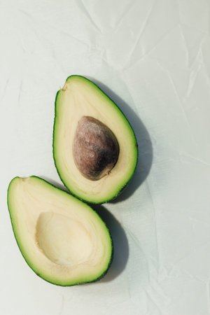 Green ripe avocado on a light background, healthy food concept.の写真素材