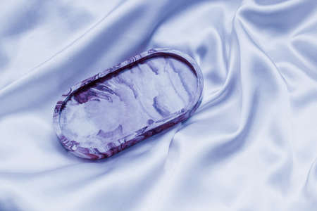 Gypsum marble decorative stand on the background of silk stand.の写真素材